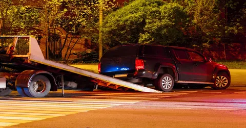 Tow truck helping a broken-down car