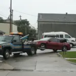 Tow truck towing a car from a parking lot — how to dispute a towing charge